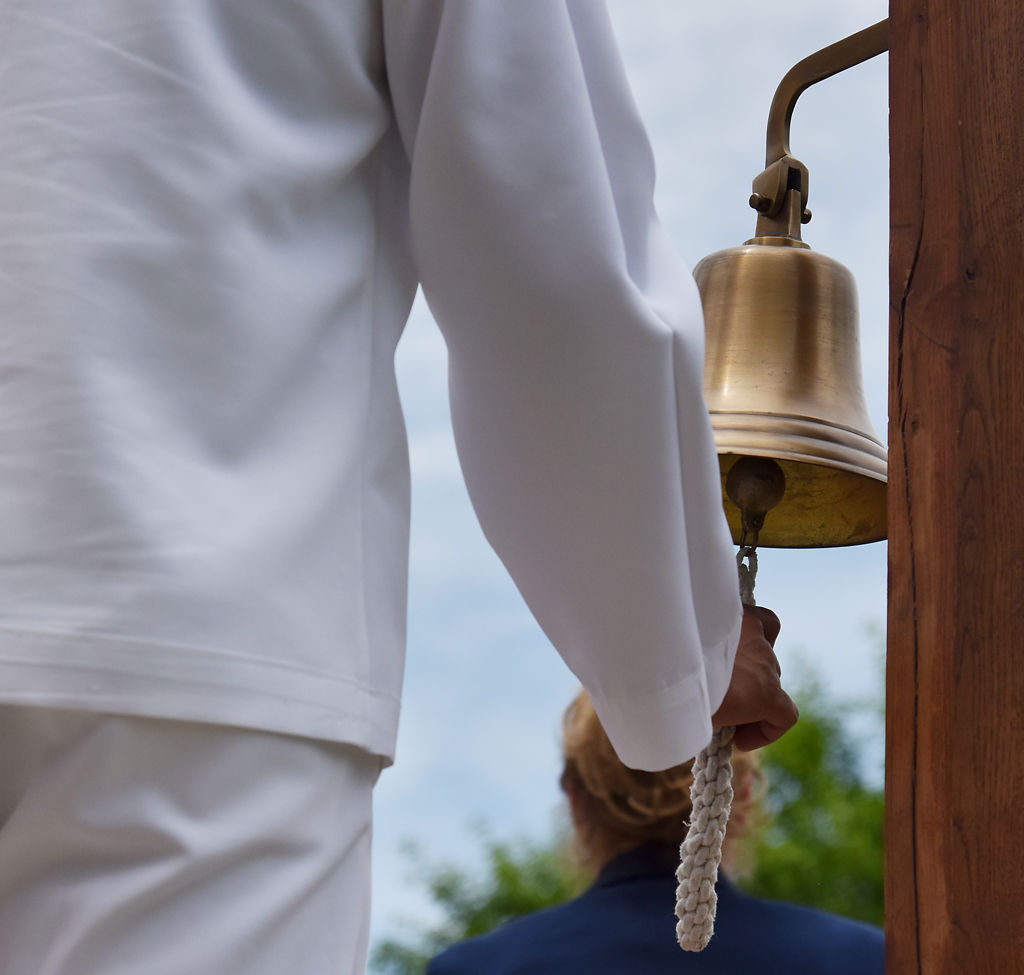 A member of the U.S. Navy rings the Navy Bell